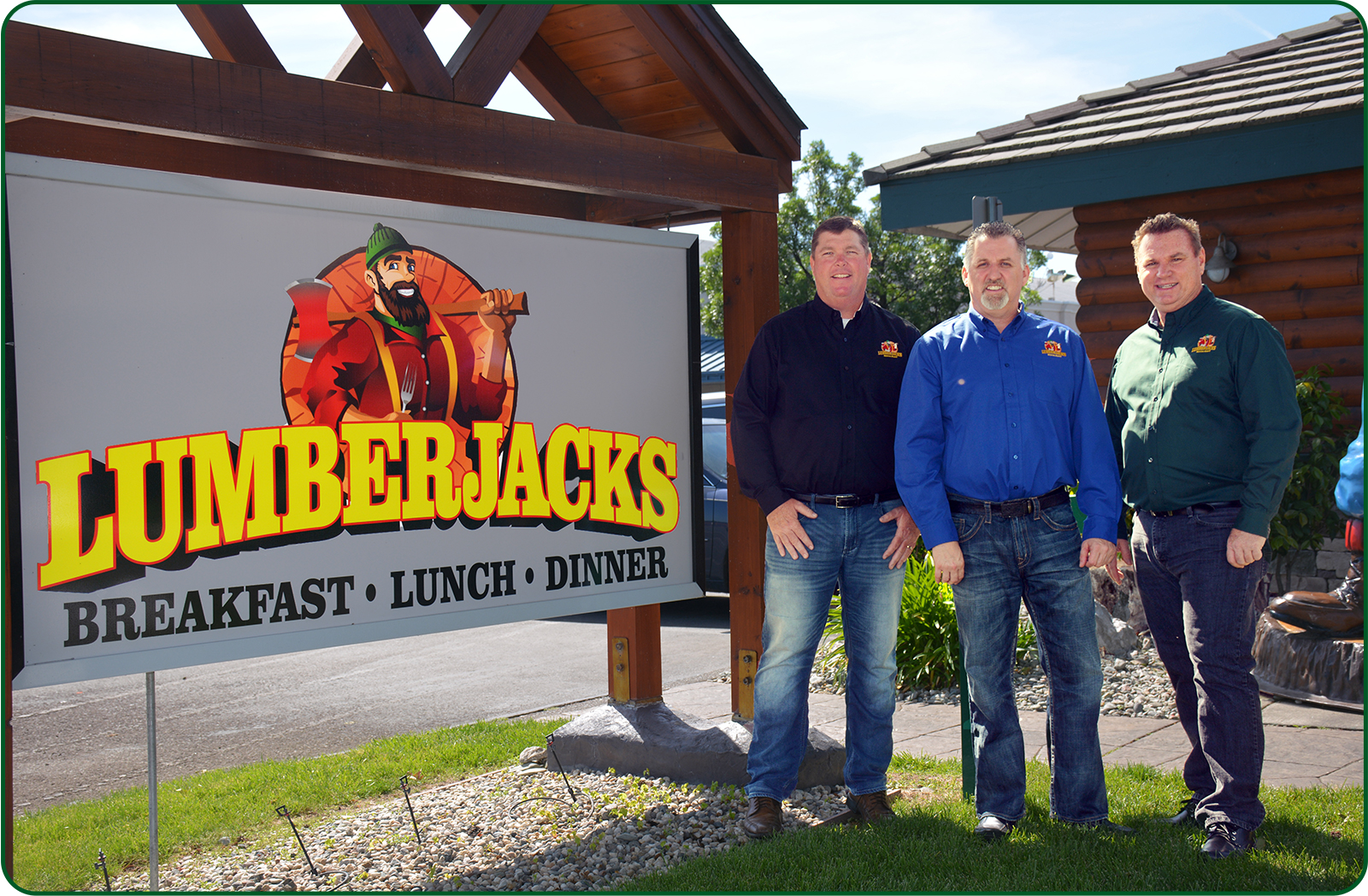 Lumberjacks Leadership Pose For Picture By Lumberjacks Sign. Sign reads: Lumberjacks - Breakfast, Lunch, Dinner